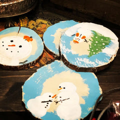 Snow Men painted on wood slabs